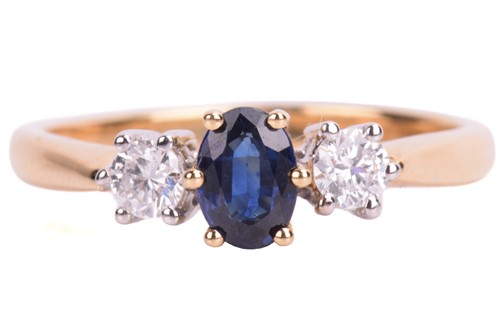 Lot 39 - A sapphire and diamond trilogy ring in 18ct bi-...