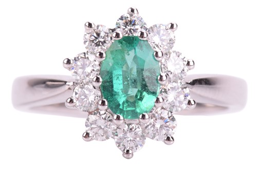 Lot 141 - An emerald and diamond cluster ring in 18ct...