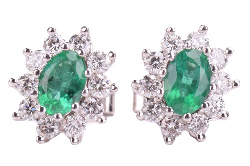 Lot 293 - A pair of emerald and diamond cluster earrings...