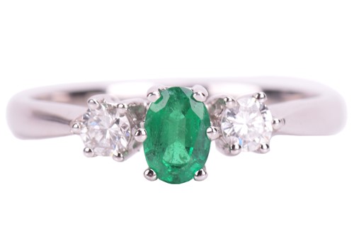 Lot 212 - An emerald and diamond trilogy ring in 18ct...