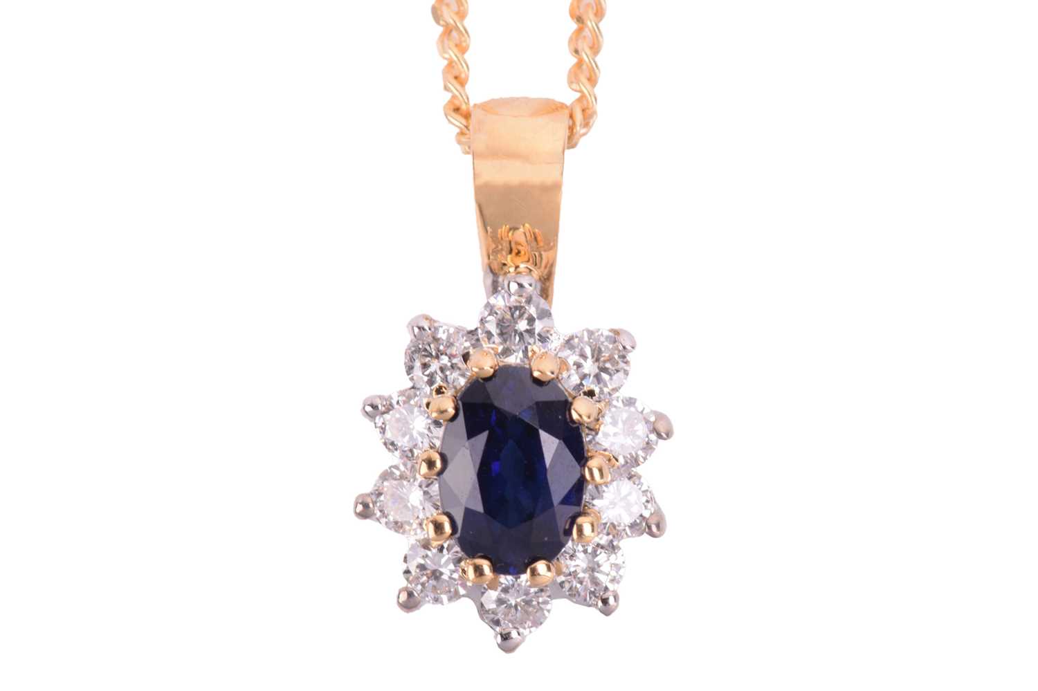 Lot 24 - A sapphire and diamond cluster pendant in 18ct...