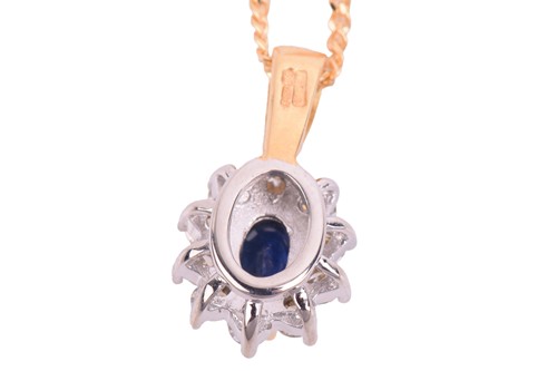 Lot 24 - A sapphire and diamond cluster pendant in 18ct...