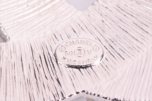 Lot 149 - Chanel. A double C interlocking logo brooch,...