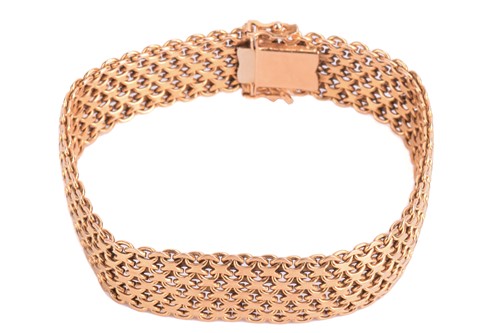 Lot 7 - A gold mesh bracelet, measuring 15.5mm and...