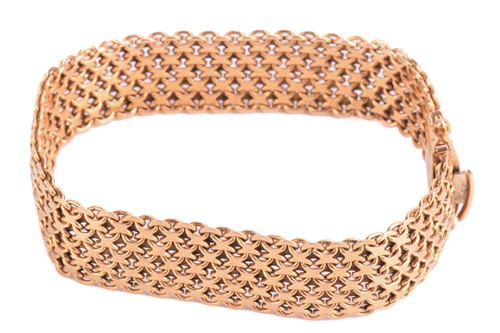 Lot 7 - A gold mesh bracelet, measuring 15.5mm and...