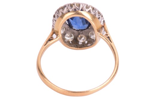 Lot 75 - A sapphire and diamond cluster ring. Oval-cut...