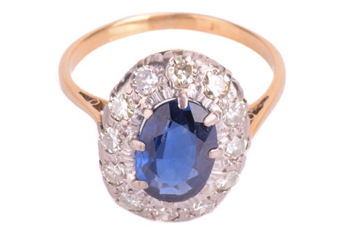 Lot 75 - A sapphire and diamond cluster ring. Oval-cut...