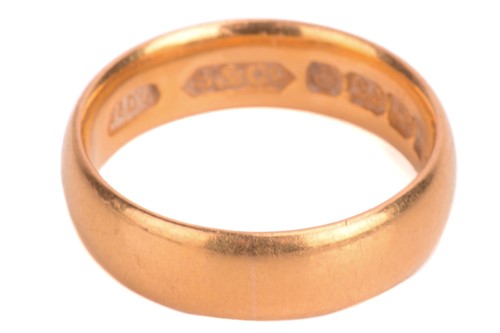 Lot 91 - A 22ct court shape wedding ring, ring size K,...