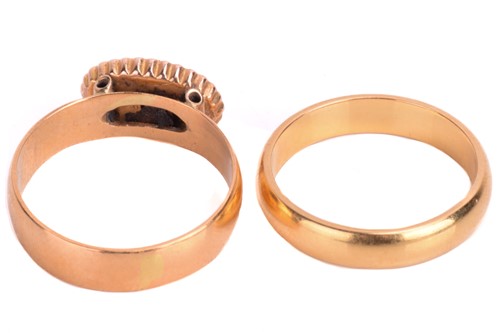 Lot 122 - Two 22ct gold rings. The dress ring is set...