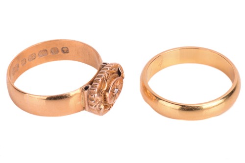 Lot 122 - Two 22ct gold rings. The dress ring is set...