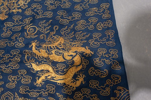 Lot 113 - A Chinese blue silk Jifu nine dragon...