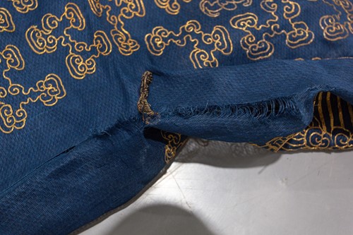 Lot 113 - A Chinese blue silk Jifu nine dragon...