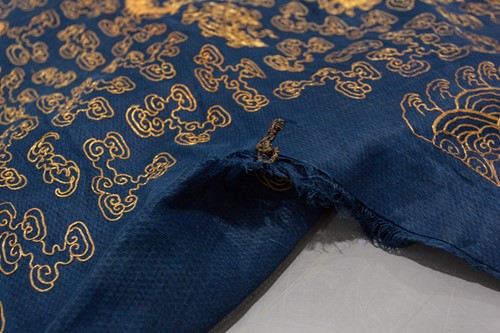 Lot 113 - A Chinese blue silk Jifu nine dragon...