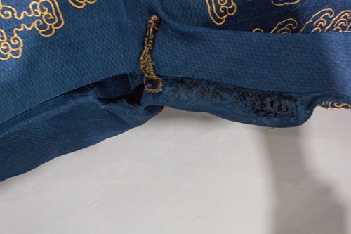 Lot 113 - A Chinese blue silk Jifu nine dragon...