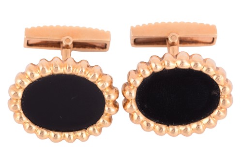 Lot 134 - A pair of onyx-set cufflinks, each inset with...