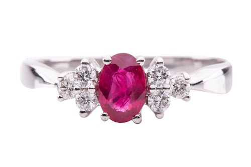 Lot 114 - A ruby and diamond ring, centred with an...