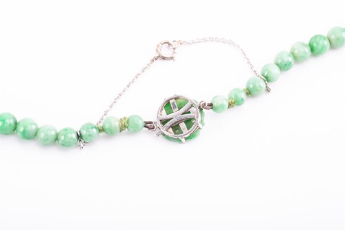 Lot 26 - A graduated jadeite bead necklace, of opaque...