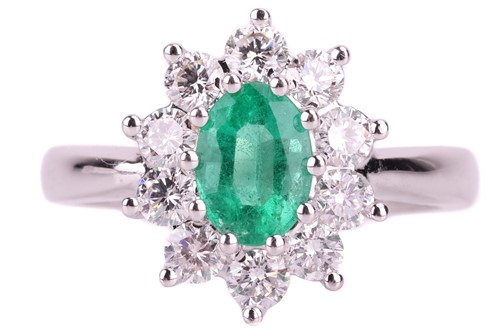 Lot 120 - An emerald and diamond cluster ring in 18ct...