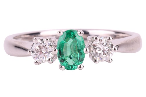 Lot 66 - An emerald and diamond trilogy ring in 18ct...