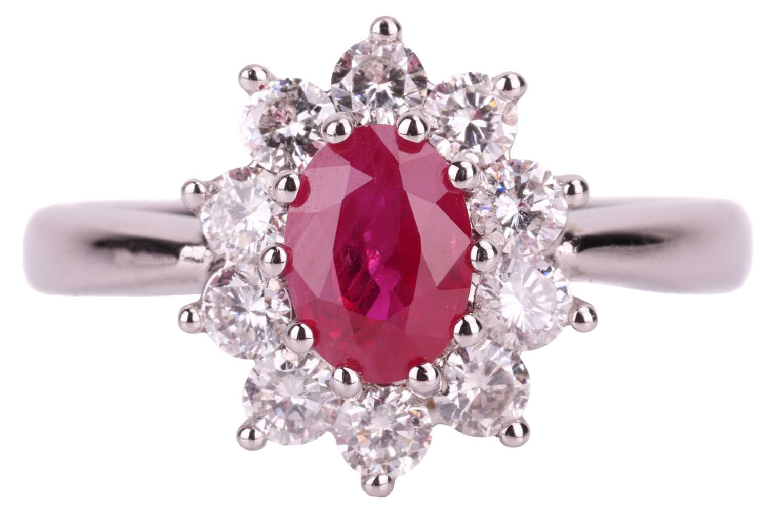 Lot 56 - A ruby and diamond halo ring in 18ct white...