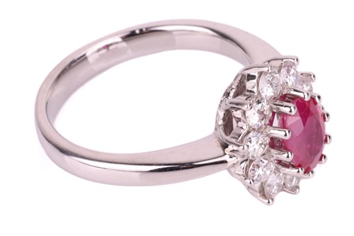 Lot 56 - A ruby and diamond halo ring in 18ct white...