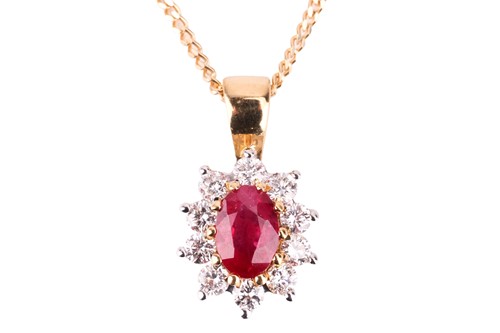 Lot 140 - A ruby and diamond cluster pendant, set in...