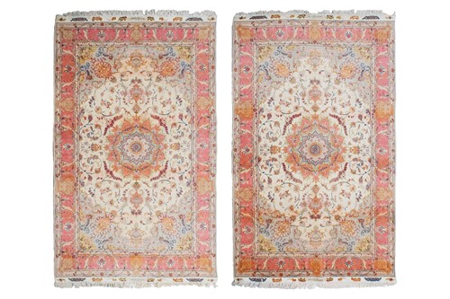 Lot 201 - A pair of fine ivory ground Tabriz Carpets...