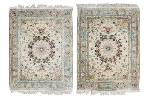 Lot 194 - A pair of Ivory ground Tabriz rugs with...