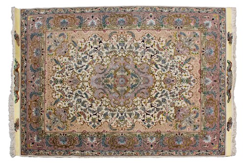 Lot 197 - An ivory ground Tabriz rug with "Bookcover"...