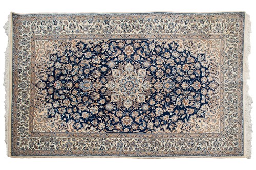 Lot 198 - A navy blue ground Nain rug with central...