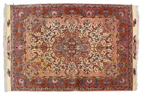 Lot 196 - An ivory ground Tabriz rug with a "Bookcover"...