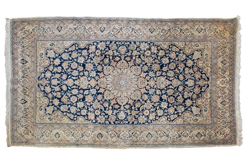 Lot 199 - A navy blue ground Nain carpet with lobed...