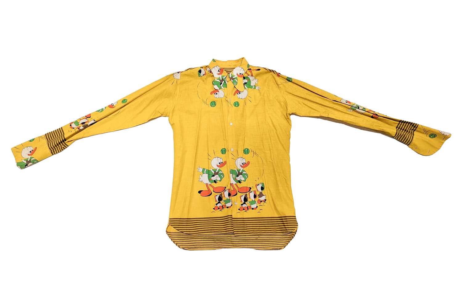 Lot 329 - A 1960s beagle-collared yellow shirt, from the...