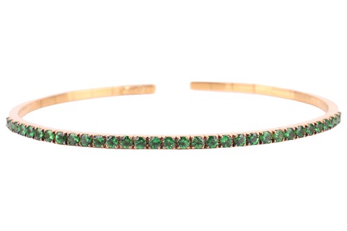 Lot 138 - A tsavorite-set flexible open bracelet,...