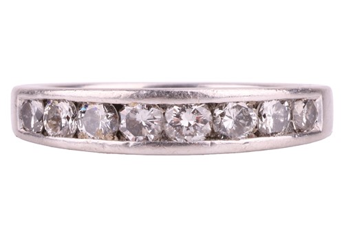Lot 9 - A diamond half-eternity ring in platinum,...