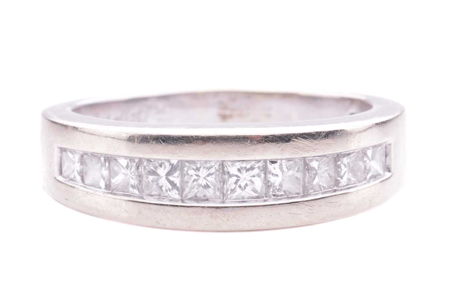 Lot 14 - A princess-cut diamond half-hoop ring, channel-...