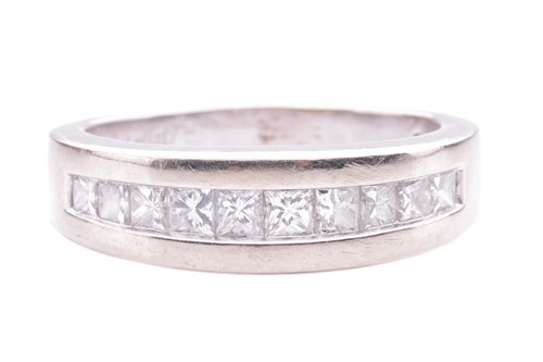 Lot 14 - A princess-cut diamond half-hoop ring, channel-...