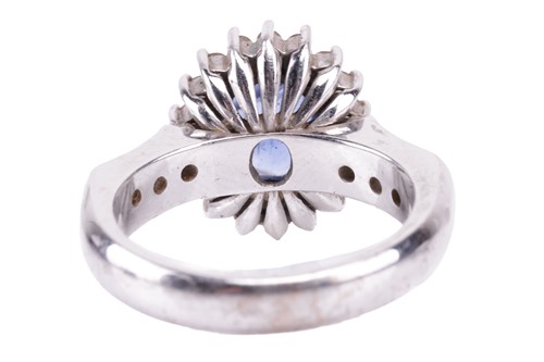 Lot 155 - A sapphire and diamond cluster ring; the oval...