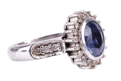 Lot 155 - A sapphire and diamond cluster ring; the oval...