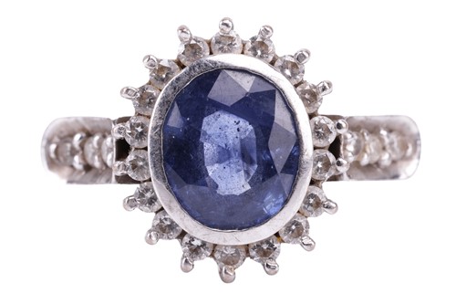 Lot 155 - A sapphire and diamond cluster ring; the oval...