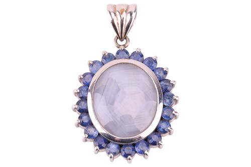 Lot 59 - A star sapphire halo pendant; comprising a...