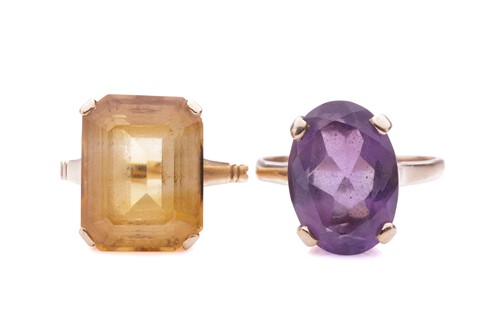 Lot 135 - An amethyst dress ring and a citrine dress...