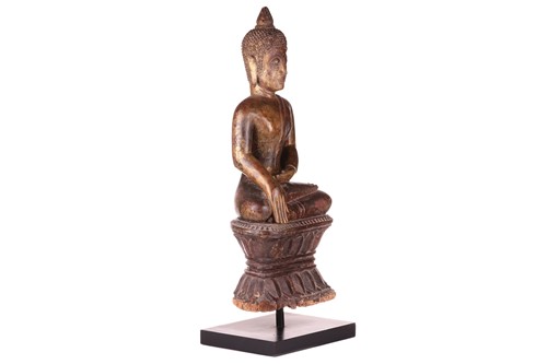 Lot 54 - A Siamese carved and giltwood, seated Buddha...