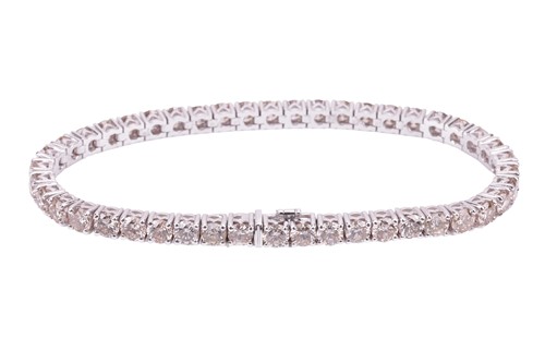 Lot 144 - A diamond line bracelet, containing a row of...