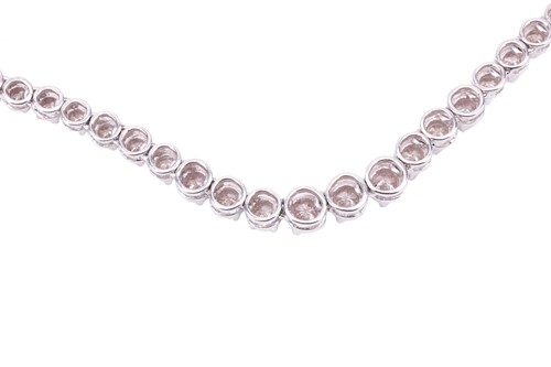 Lot 94 - A diamond line necklace set with a single row...