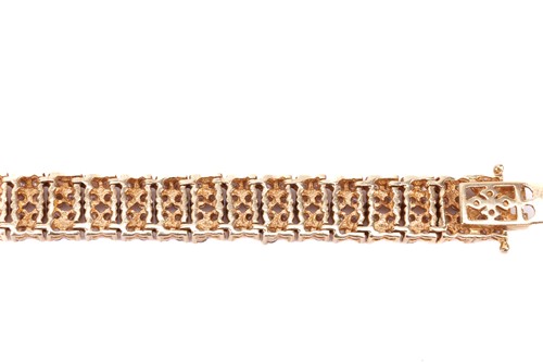 Lot 21 - A diamond-set link bracelet in 18ct yellow...