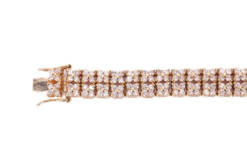 Lot 21 - A diamond-set link bracelet in 18ct yellow...