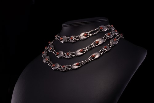 Lot 208 - Georg Jensen - a triple-strand floral necklace...