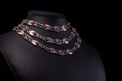 Lot 208 - Georg Jensen - a triple-strand floral necklace...