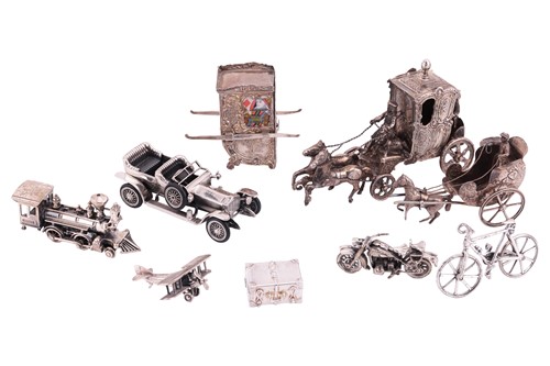Lot 267 - A collection of silver travel-themed miniature...